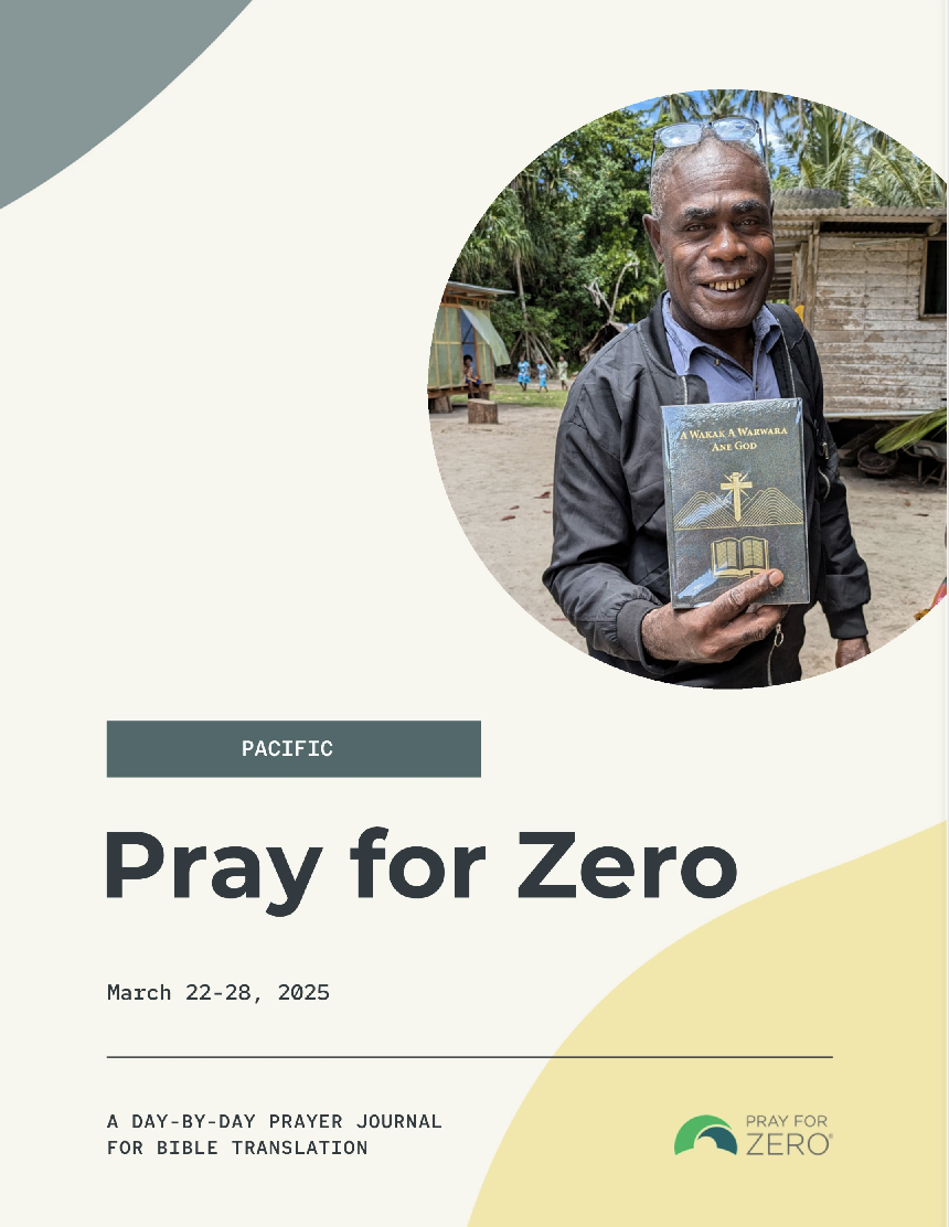 Cover of the Pray for Zero Pacific prayer journal featuring a smiling man holding a newly translated Bible, with a village setting in the background.